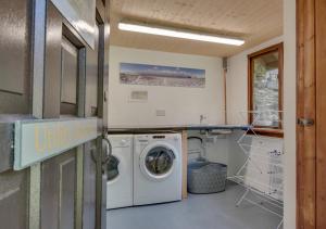a laundry room with a washer and dryer at The Stable in Trentishoe