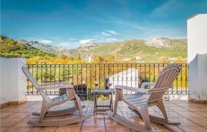 two chairs and a table on a balcony with mountains at Spacious villa with private pool near Priego de Cordoba in Priego de Córdoba