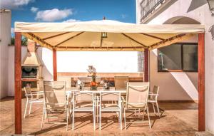a table and chairs under a tent on a patio at Spacious villa with private pool near Priego de Cordoba in Priego de Córdoba