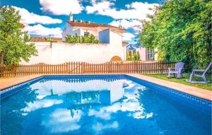 a swimming pool in front of a house with a fence at 5 bedrooms villa with private pool furnished terrace and wifi at Priego de Cordoba in Priego de Córdoba