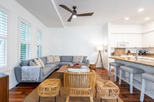 a living room with a couch and a table at Sunset Villa - Walk To Koolina Beaches - Sleeps 8 in Kapolei