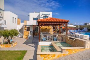 a villa with a pool and a gazebo at Ledra Maleme Hotel in Maleme