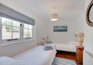 a bedroom with two beds and a window at Sunnymead in Barnstaple