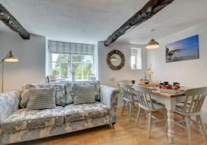 a living room with a couch and a table at Sunnymead in Barnstaple