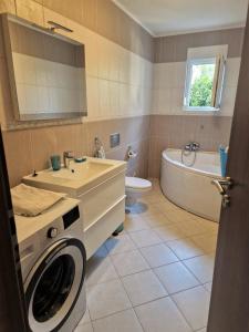 a bathroom with a washing machine and a sink at Villa Petra in Rab +37 photos