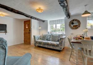 a living room with a couch and a table at Sunnymead in Barnstaple