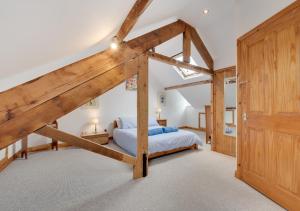 a bedroom with a bed with a wooden frame at Temperance Cottage in Braunton