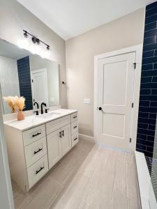 a bathroom with a sink and a mirror at Swanky Seahorse in Carolina Beach
