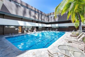 a swimming pool in front of a building at Stunning Skyview, Pool, Fabulous Location! in Honolulu