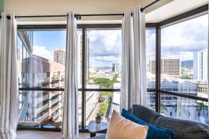 a living room with a large window with white curtains at Spacious Downtown Executive Retreat - Free Parking in Honolulu