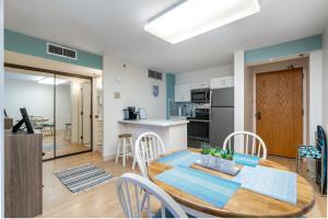 a kitchen and dining room with a table and chairs at Spacious Downtown Executive Retreat - Free Parking in Honolulu