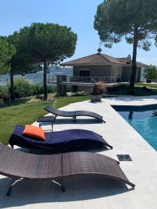 a couple of pillows sitting next to a swimming pool at GreenValley BnB in Lapedona +56 photos