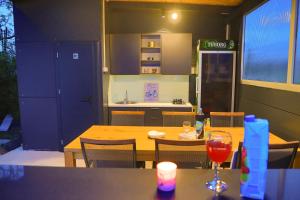 a dining room with a table and a kitchen at Holiday Home Libera in Bihać