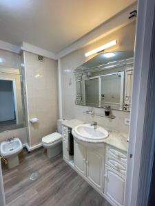 La salle de bains est pourvue d'un lavabo, de toilettes et d'un miroir. dans l'établissement Milladoiro, à Teo