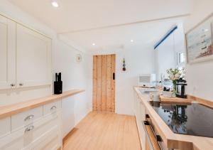 a kitchen with white cabinets and a counter top at Thyme at South Worden 