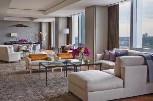 
a living room filled with furniture and a large window at Four Seasons Hotel Toronto at Yorkville in Toronto
