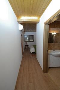 a hallway leading to a bathroom with a sink and a mirror at Large Modern Villa in Celorico de Basto with Private Pool in Celorico de Basto