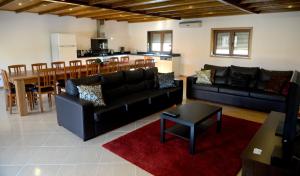 a living room with a couch and a table and a kitchen at Large Modern Villa in Celorico de Basto with Private Pool in Celorico de Basto