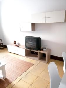 a living room with a television on a table at 4 bedrooms appartement at Bueu in Bueu