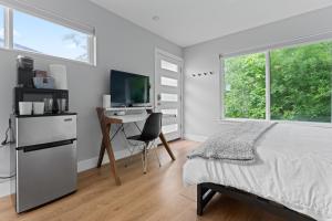 um quarto com uma cama, uma secretária e uma televisão em Detached 1 Bed 1 Bath In-law Suite 3 miles from Downtown! em Austin