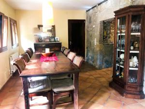 a dining room with a wooden table and chairs at 2 bedrooms villa with private pool enclosed garden and wifi at Castellbell i el Vilar in San Vicente de Castellet