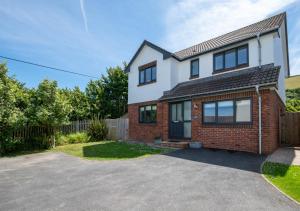 a house with a driveway in front of it at Withyside in Croyde