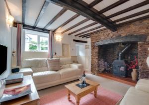 a living room with a couch and a fireplace at Willow Cottage in Braunton