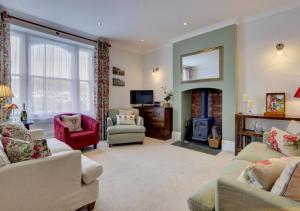 a living room with a couch and a fireplace at Wyndham Villa in Braunton