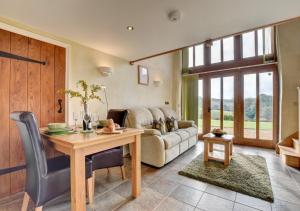 a living room with a table and a couch at Workshop in Bampton