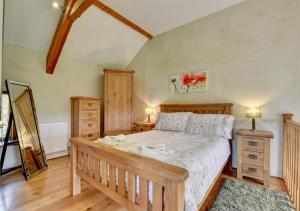 a bedroom with a bed and two dressers at Workshop in Bampton