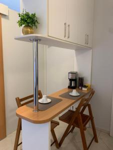 a kitchen with a wooden table with a coffee maker on it at Apart Hotel Centro de Brasília (Garvey Park Hotel) in Brasilia