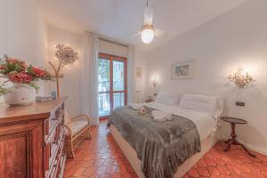 a bedroom with a bed and a table and a window at RAPALLO APARTMENT Comodo e in Ottima Posizione in Rapallo +23 photos