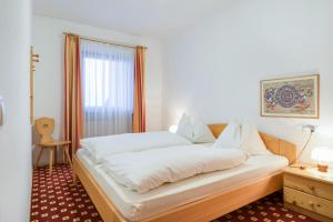 A bed or beds in a room at Apparthotel Feldhof - Living and Bistro