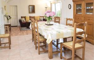 a dining room and living room with a table and chairs at Beautiful Home In Lestre With 3 Bedrooms And Wifi in Quinéville