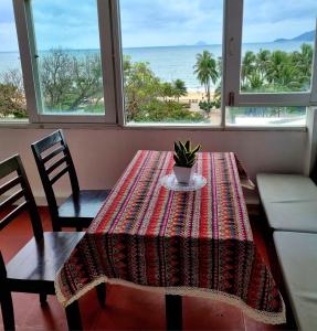 a dining room table with a potted plant on top of it at PHỐ BIỂN HOTEL in Nha Trang