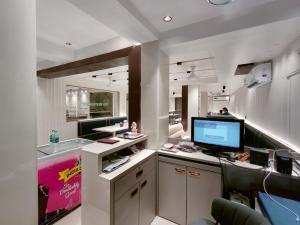 an office with a desk with a computer on it at Hotel Anand Palace in Shirdi