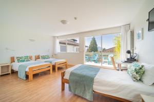 a bedroom with two beds and a large window at Centre Jean XXIII in Annecy