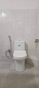 a white toilet in a bathroom with a shower at Tea corner Guest house in Darjeeling