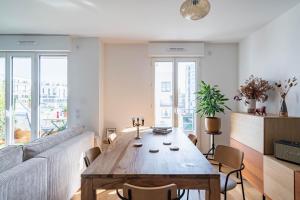 a living room with a wooden table and a couch at Stunning apartment with balcony to visit Paris in Paris