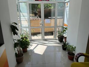 an open door with potted plants in a room at SARVAR in Dushanbe