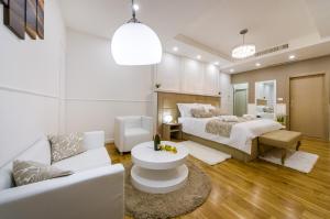 a bedroom with two beds and a couch at Peninsula Luxury Suite in Zadar