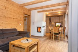 a living room with a couch and a table at Chalet Mandl Sauna Pool Rollstuhlgängig in Maishofen