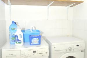 a laundry room with a detergent and a washing machine at 2 bedrooms appartement with wifi at San Cristobal de La Laguna in Las Lagunas