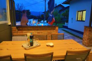 a wooden table with a drink on top of it at Holiday Home Libera in Bihać +91 photos