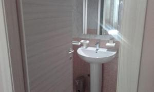 a bathroom with a white sink and a mirror at HOTEL DED 1 in Parma