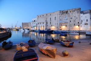 a group of boats parked in front of a building at 2 bedrooms house with city view enclosed garden and wifi at Ostuni in Cisternino