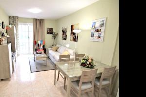 a living room with a table and a couch at 2 bedrooms appartement with wifi at San Cristobal de La Laguna in Las Lagunas