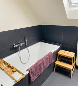 Das Bad ist mit einer Badewanne mit einer Dusche ausgestattet. in der Unterkunft BeauVenue in Veurne