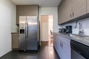 a kitchen with a stainless steel refrigerator in it at 3 BR with Splendid River views in New York
