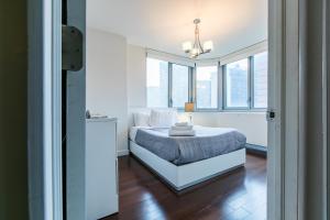a bedroom with a bed and some windows at 3 BR with Splendid River views in New York